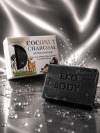 Eko Body coconut charcoal soap bar with packaging on a reflective surface